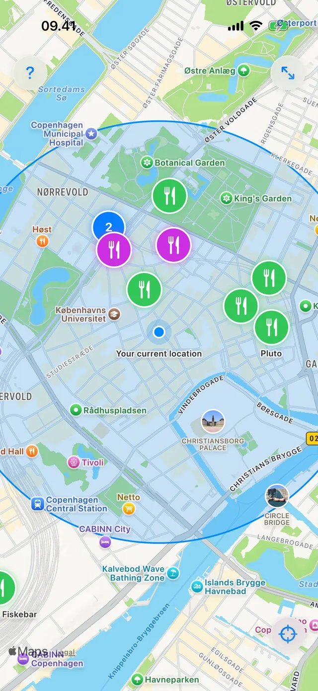 A map of central Copenhagen with dozens of restaurant pins, dense areas collapsed into numbered clusters
